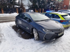 granatowy pojazd i radiowóz